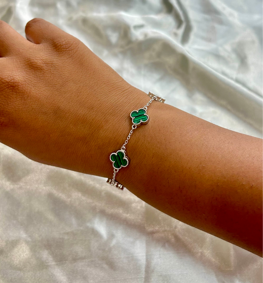 florin bracelet with clover charms on a wrist, silver bracelet,