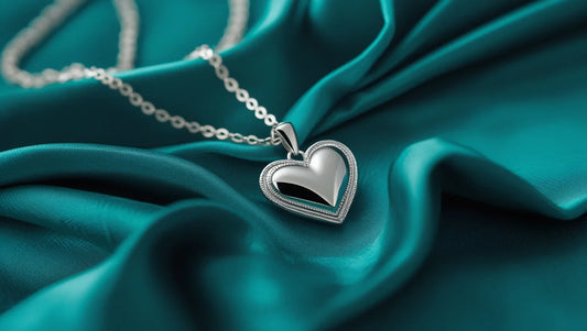 necklaces, silver necklace on a teal background, necklace with heart shaped pendant,